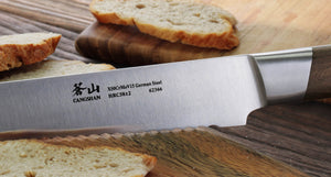 
                  
                    Load image into Gallery viewer, R Series 10.24-Inch Bread Knife with Ash Wood Sheath, Forged German Steel, 62649
                  
                